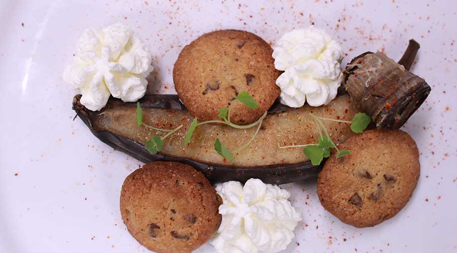 Banane rôtie dans sa peau flambée au Koloa, chantilly à la fève de tonka et cookies au chocolat